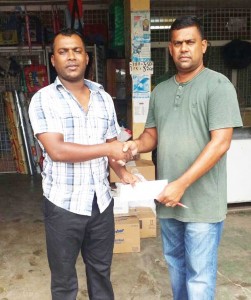 Wahied Edwards (left), YWCC senior team Captain collects the sponsorship cheque from Sahidrul Satar. 