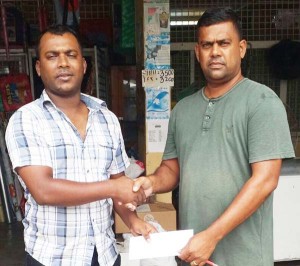 Wahied Edwards (left), YWCC senior team Captain collects the sponsorship cheque from Sahidrul Satar. 