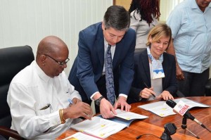 Minister of Finance ,Winston Jordan, and Sophie Sirtaine, World Bank Country Director, Caribbean Country Management Unit Latin America and the Caribbean Region, sign the US$3M agreement for the rehabilitation of the Cunha Canal