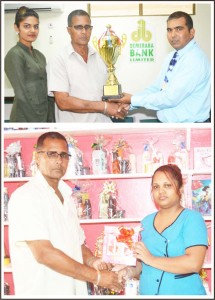(Above): Omadatt of DBL hands over cheque to UCCA president Dennis D’Andrade. (Below) Taruna Harinarine of Venu Shopping Center and Beauty Salon hands over cheque to UCCA president Dennis D’Andrade. 