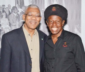 President David Granger with renowned Guyanese singer, Eddy Grant, at the Ministry of the Presidency yesterday.