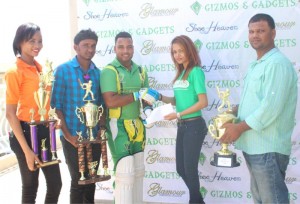  Niketa Jackson (Web express representative) and Bonita Bisessar (Company secretary) of Gizmos and Gadgets hands over the Sponsorship Cheque to RHTYSC Captain Shawn Perriera. 