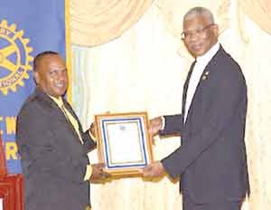 esident Granger receives a token from the President of the Rotary Club of New Amsterdam, Mr. Chris Hicks