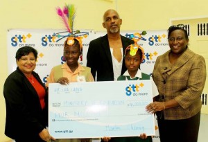  GTT’s Marketing Manager Anjanie Hackett presents a sponsorship cheque to the Education Ministry’s Children Mash convener Desiree Wyles-Ogle in the presence of Designer Derek Moore and two students. 