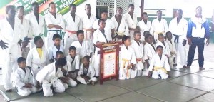 Guyana Judo Association President Raoul Archer (right) share the moment with his outstanding charges at the competition last Sunday at MYO.