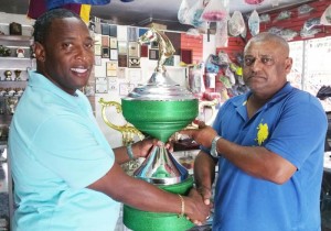 Banks DIH Limited Manager Mortimer Stewart (left) presents the beautiful Banks DIH Trophy to organiser Fazal Habibulla compliments of Trophy Stall. 