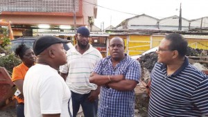 Town Clerk Royston King and City Public Relations Officer (Ag) Debra Lewis engage residents of Charlestown on the clean up exercise in La Penitence Market and environs.