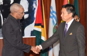 President Granger greets Mr. Mutsuhito Okada yesterday at the Ministry of the Presidency.