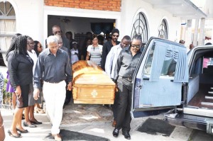 Pallbearers transport the casket of the late national Netballer Angeline Dyer-McCarthy to the hearse at the Lyken Funeral Parlour yesterday. 