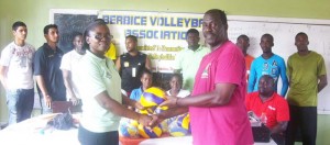 BVA president Levi Nedd presents the Volleyball equipment to Inga Henry of the Ministry of Education in the presence of other officials. 