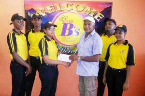 Abeeda Ali of Big B’s Restaurant presents the cheque to Mohamed Samad in the presence of her colleagues.