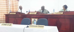 Chairman Justice James Patterson (centre) and Commissioner Mrs. Merle Mendonca (right) make notes as Commissioner Mr. Dale Erskine looks over at the witness stand during yesterday’s proceedings.