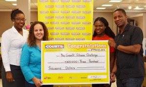 Marketing Manager Pernell Cummings (right) hands over the cheque to Event Organiser Jordana Ramsay-Gonsalves in the presence of Noshavyah King (2nd right) and Marketing Officer Roberta Ferguson yesterday.