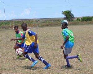 Players from Dolphin Secondary and Richard Ishmael battle for possession in their encounter yesterday.