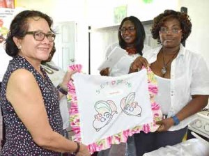 Mrs. Granger receives a locally made, embroidered pillowcase from one of the ladies who benefited from the five-day workshop 
