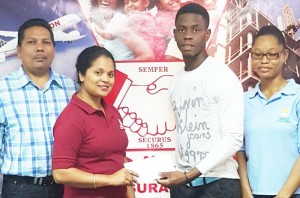  Hand-in-Hand employee Eshwarie Persaud (left), hands over the sponsorship cheque to YWCC, Guyana and West Indies youth batting sensation Shimron Hetmyer in the presence of Berbice Manager Tajpaul Adjhodea.