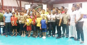 GTTA President, Godfrey Munroe (right) and sponsor Arron Fraser (left) join the winners from the GTTA National Junior and Cadet Table Tennis Championships for a photo opportunity at the National Gymnasium Sunday night.