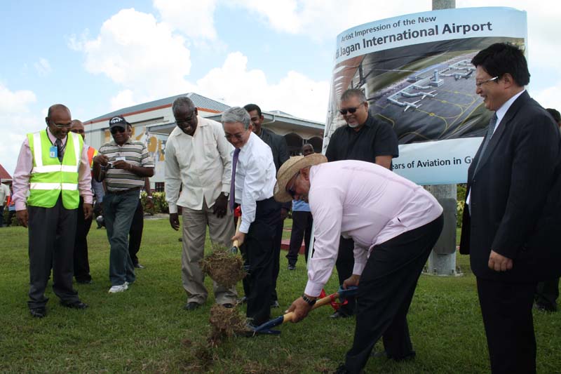 CHEC and airport officials, along with former President Donald Ramotar and former Public Works Minister Robeson Benn, as they turn the sod for the beginning of the project.