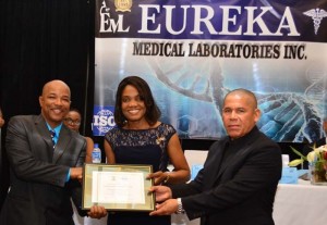 (From left) CEO of Eureka Medical Laboratory, Andrew Boyle receives the Certificate of International Accreditation from JANAAC CEO , Sharonmae Shirley and Public Health Minister, Dr. George Norton 