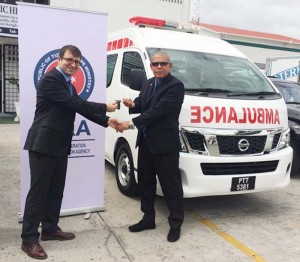 Minister of Public Health, Dr. George Norton receives the keys to the ambulances from Mehmet Ozkan, representative of the Turkish Government (GINA)