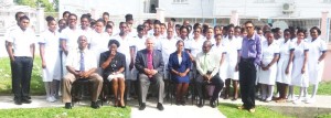 Public Health Minister George Norton (sitting at centre) poses with the 64 trainee Patient Care Assistants and other health officials. 