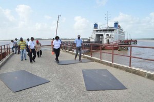 Minister within the Ministry of Public Infrastructure, Annette Ferguson, along with a group of engineers inspecting the Supenaam stelling, Essequibo coast.
