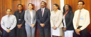 Attorney General and Minister of Legal Affairs, Basil Williams (centre) with Board members of the Deeds and Commercial Registries Authority.