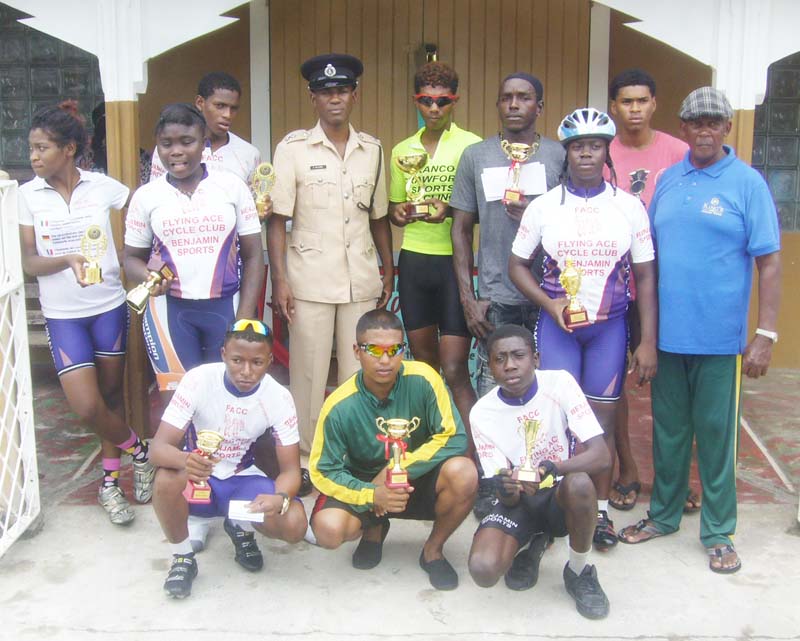 Top finishers pose with their silverware alongside organisers ASP Keith Williams (centre in uniform) and Randolph Roberts (right). 