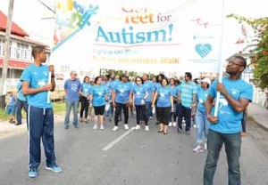 First Lady, Mrs. Sandra Granger (centre) is flanked by (left) Minister of Education, Dr. Rupert Roopnaraine and Minister of Public Security, Mr. Khemraj Ramjattan (far right) among other supporters at the Autism Awareness walk. (Photo compliments of the Ministry of the Presidency)
