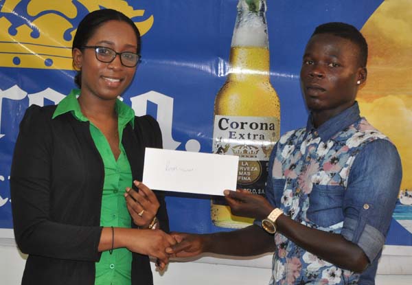 Top Brandz Marketing Rep. Ms Lise Lewis hands over the winner’s cheque to Denzil Pryce of Royal Youths.