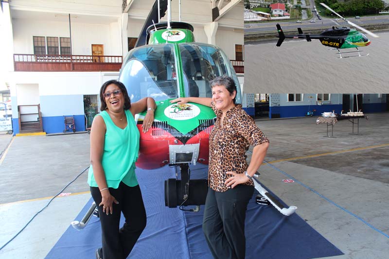 Minister of Tourism, Catherine Hughes (Left) and ASL’s Manager, Annette Arjoon-Martins, during the unveiling ceremony yesterday.  (Inset) The rebranded helicopter during a recent fly-about along the Georgetown Seawall. 