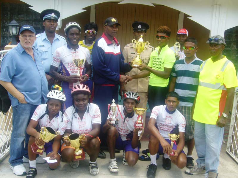 Commander of Police B Division Assistant Commissioner Ian Amsterdam (in track suit) presents the winning Commander B Division trophy to winner Ray Millington. Also sharing the moment along with the other outstanding performers are Mr. Alphonso (left), Station Sergeant of the Central Police Station Marlon O’Donaghue (2nd left) and ASP Williams (centre), while Coach Roberts is at right. 