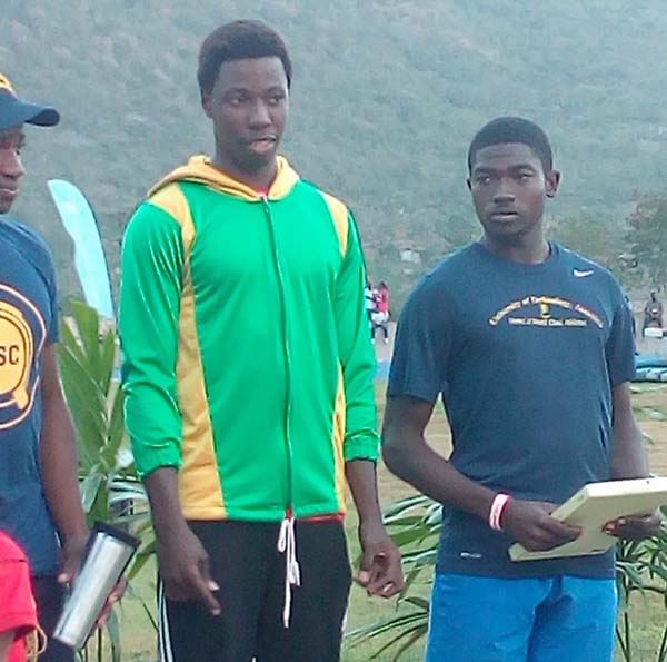 Emmanuel Archibald (centre) on top of the podium in Jamaica at UWI’s Invitational. Archibald won two individual medals for the University of Guyana in the long and triple jumps.