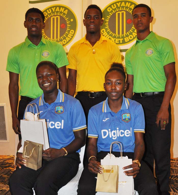 From extreme right standing, Kemo Paul, Shemron Hetymer and Tevin Imlach. Sitting, Tremayne Smartt (left) and Shamaine Campbell were honored for being members of West Indies World Cup success this year. 