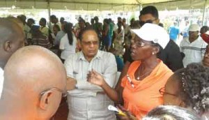 Acting President and Prime Minister Moses Nagamootoo listens attentively to the concerns of a Region Six resident.