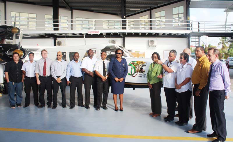 Government Ministers, Annette Furguson (eighth from left) and Catherine Hughes (Fifth from right) flanked by members of the Private Sector, Aviation and Tourism fraternities, along with other stakeholders with the triple-engine Britten Norman Trislander in the background. 