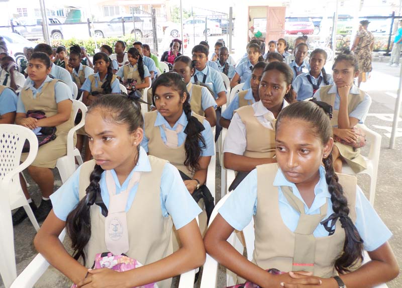 Students listen attentively during a health talk yesterday. 