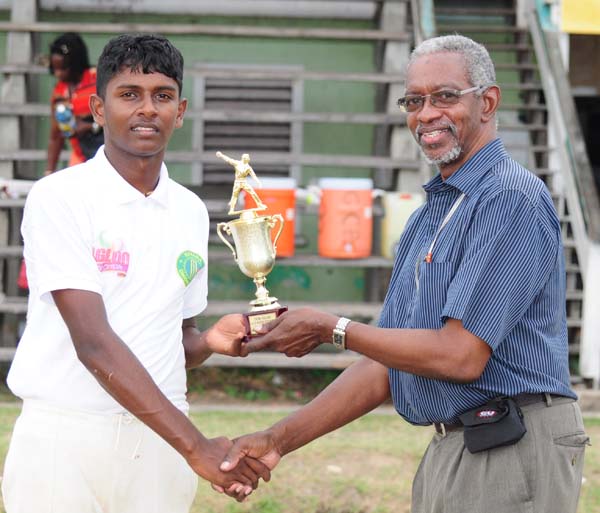  Man-of-the-match Sagar Hathiramani accepts his prize from match referee Grantley Culbard. 