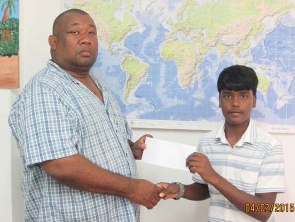 Fadil Hakh of F&H Printery hands over cheque to RHTYSC Secretary/CEO Hilbert Foster.