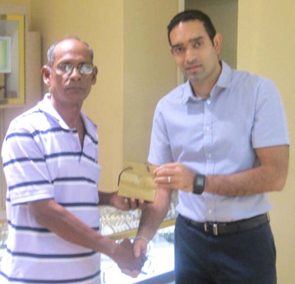 RHTYSC, MS Asst Organising Secretary Ravin Kissoonlall receives Medallion from Kings Managing Director, Ryan Persaud.