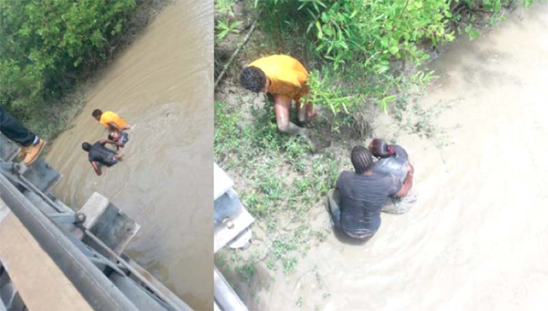 Rescuers assisting the young woman from the Demerara River yesterday. (Newssourcegy.com photo)