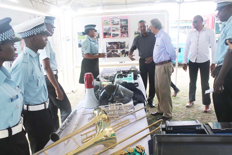 Min. of Education Dr. Rupert Roopnarine accompanied by Comm. of Police, Seelall Persaud examines a booth at the GPF Career Day.