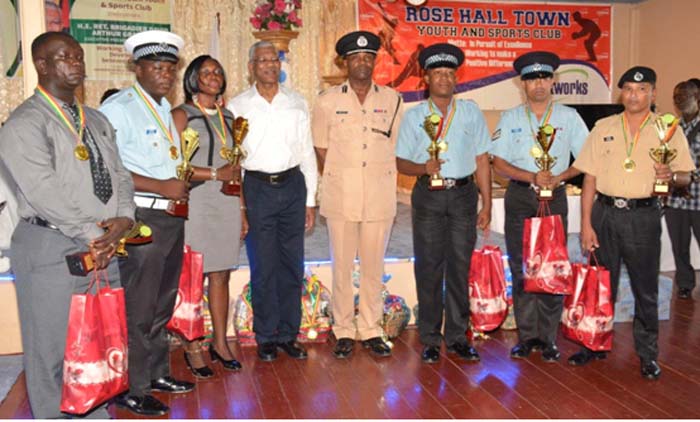 President Granger and Commander Amsterdam pose with the awardees.