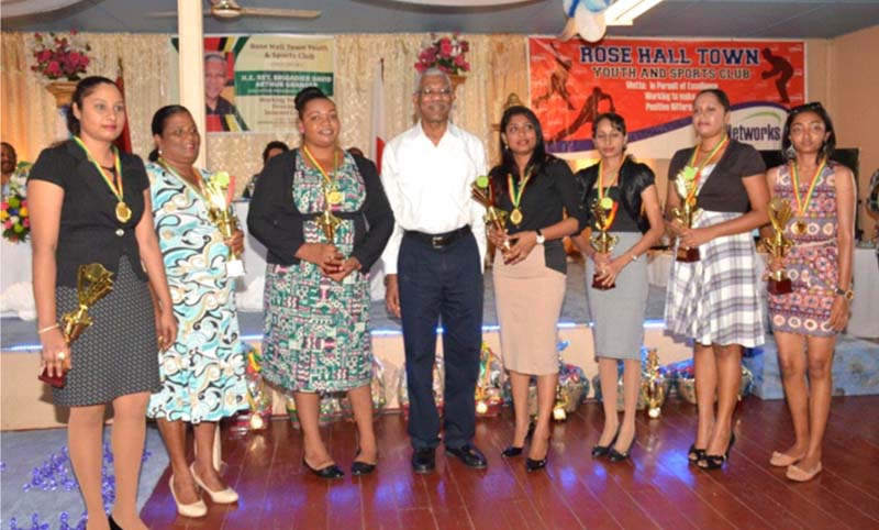 President Granger poses with seven of the eight Tribute to Outstanding Teachers Awardees.