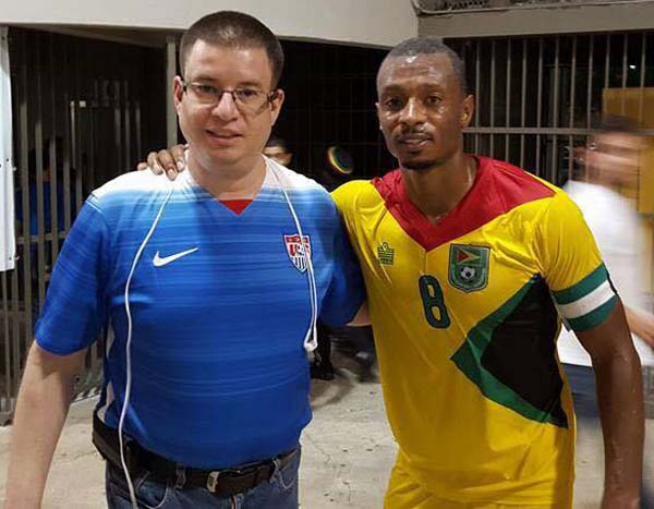 Christopher Nurse pictured with a Puerto Rican fan following Guyana’s win in the Men’s Caribbean Cup on March 29th last.