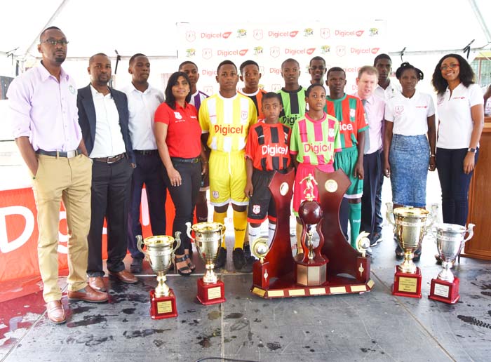 Digicel’s CEO Kevin Kelly (4th right) poses with Company executives, Director of Sport Chris Jones (left), GFF President Wayne Forde (next to him)and schools representatives yesterday.