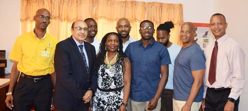 Olympics bound Troy Doris (third, left) pose with GOA President, K. A Juman Yassin (second, left), Chef-de-Mission, Garfield Wiltshire (left), AAG President, Aubrey Hutson (right) and his family members yesterday at Olympic House.