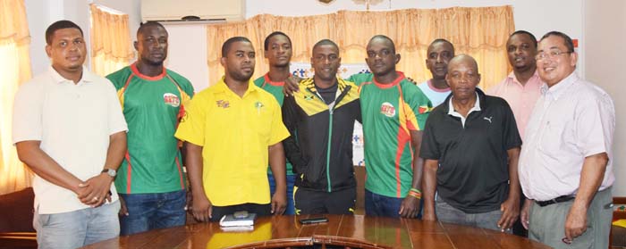 Guyana and Jamaica rugby Captains Richard Staglon and Hubert Thomas (centre) hug each other in the presence of President of the Union Peter Green (right), Jamaica Manager Tezra Sannister (3rd left) and members of the Guyana squad yesterday at Olympic House.