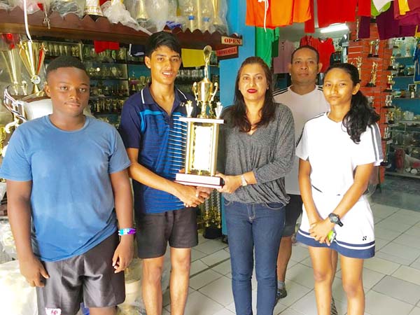 Ms. Devi Sunich of Trophy Stall, Junior Sportsman of the year Narayan Ramdhani, GBA Rep Marlon Chung and some Junior Players display some trophies that are up for grabs.
