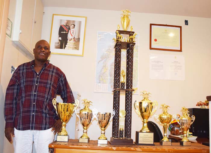 Member of the Four Horseman Promotion Organising Committee Compton Sancho poses with the trophies up for grabs at next week’s Race Meet at Pour Mourant Turf Club.